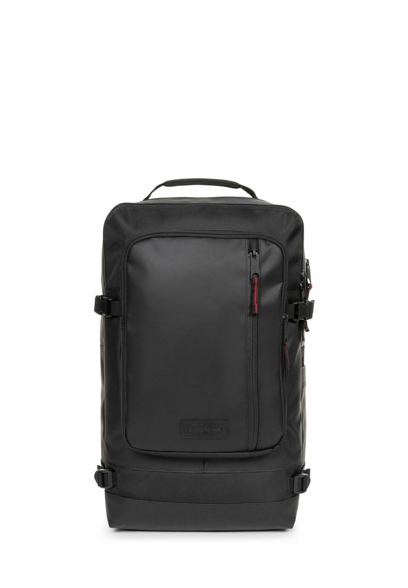 Black backpack made of durable synthetic material, featuring a front zip pocket, adjustable straps, and a top handle for easy carrying.