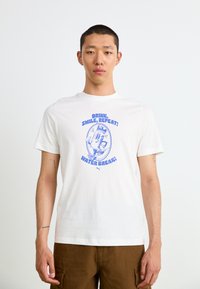 White cotton short-sleeve t-shirt featuring a blue graphic with the text “Drink, Smile, Repeat! Water Break!” and cartoon character design.