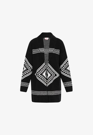 Must värviga kardigan valgete geomeetriliste mustritega, avatud esiosa, pikad varrukad ja šalli krae. Valmistatud tekstuurilisest kangast, kontrastsete detailidega.