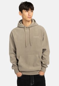 Sudadera beige de canalé con cordones, bolsillo canguro y sutil marca "Element" en el pecho. Fabricada en material suave.