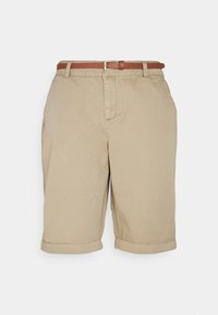 Beige puuvillashortsit, joissa on kääritty helma ja ruskea vyö. Takanapissa on vetoketju ja etutaskut, mikä antaa rentoa muotoilua.