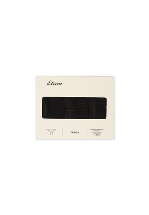 Confezione di tre perizomi neri in cotone, contenuta in un imballaggio crema etichettato "Etam" con certificazione di conversione al cotone biologico.