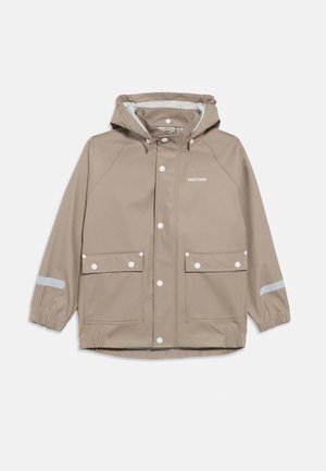 Beige hooded rain jacket with front snap buttons, two flap pockets, elastic cuffs, reflective strip on sleeves, and "TRETORN" logo on chest.