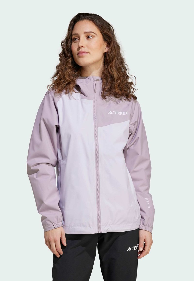 Light purple waterproof jacket with a full zip, elastic cuffs, and a branded front pocket. Features a simple, modern design.