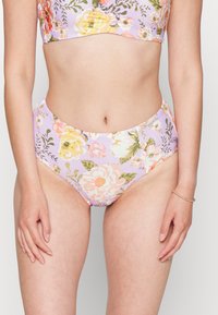 Conjunto de bikini floral com base lavanda, decorado com flores em rosa e amarelo. O top tem um design cropped e as calças são de cintura alta.