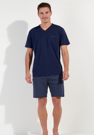 Navy V-neck T-shirt with a pocket, paired with navy shorts featuring a small white diamond pattern, smooth fabric, casual fit.
