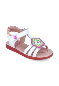 Sandal infantil blanca con tres correas, suela roja y un acento floral colorido en la parte frontal, con un diseño en rosa y verde.