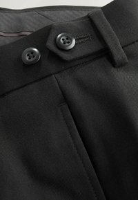 Black tailored trousers featuring smooth texture, two large black buttons, and flat front design with side pockets and neat stitching.