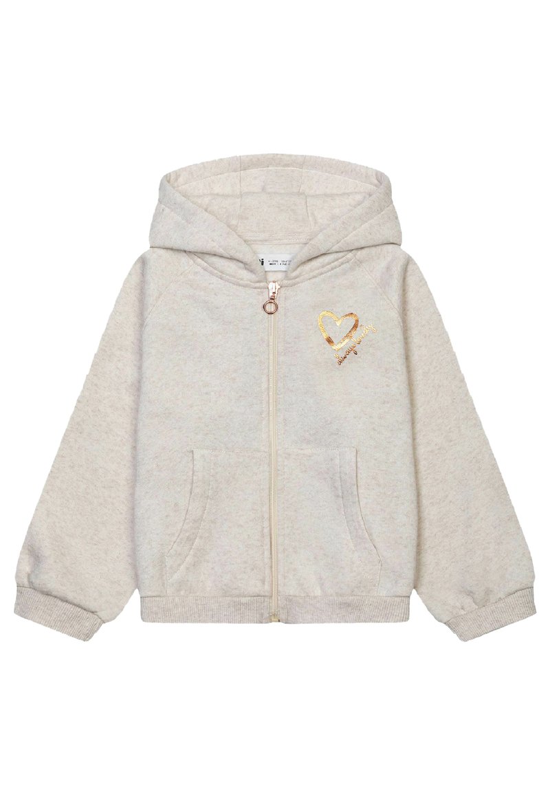 Felpa con zip color beige chiaro realizzata in morbido tessuto, con un design a forma di cuore dorato sul petto e due tasche frontali.