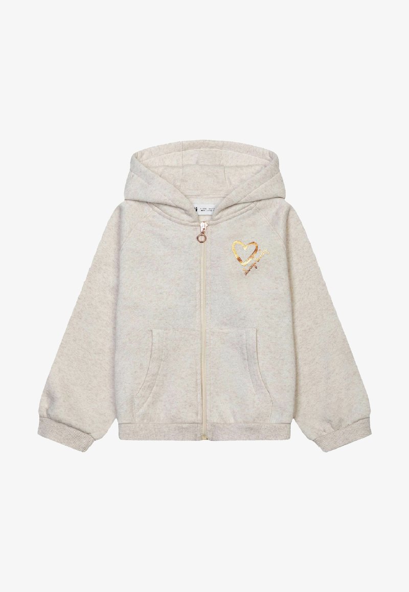 Gai bežs vilkšanas kapucis, kas izgatavots no mīksta materiāla, ar zeltītu sirds dizainu uz krūšdaļas un divām priekšējām kabatām.