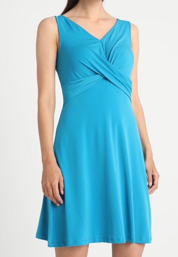 A turquoise sleeveless dress with a V-neck and twisted front detail. The fabric is smooth, and the skirt flares gently from the waist.
