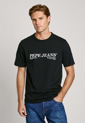 Black cotton t-shirt featuring white text “PEPE JEANS” across the front, crew neck design, short sleeves, and relaxed fit.
