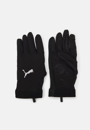 Black gloves with a smooth, textured finish, featuring a Puma logo and wave patterns on the palm for grip. Stylish, fitted design.