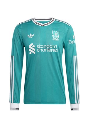 Zelena dugorukava nogometna majica s V-izrezom, bijelim detaljima, teksturiranom tkaninom te logotipima Liverpool FC-a i Standard Chartered-a.