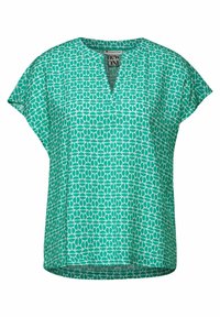 Turkusowa bluzka z dekoltem w serek i rękawami na ramiączkach. Posiada geometryczny biały wzór oraz prosty dół. Wykonana z lekkiego materiału.