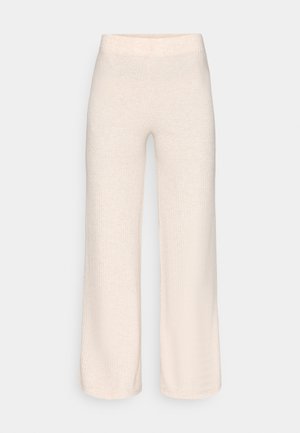 Pantalon large beige clair en tissu à texture côtelée avec une taille élastique et sans éléments métalliques visibles.