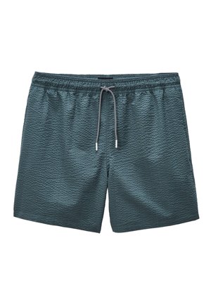 Short de bain texturé bleu sarcelle foncé avec taille élastique et cordon noir et blanc noué au centre devant.
