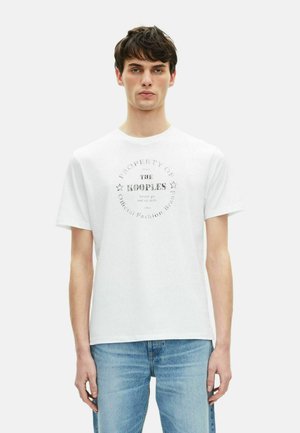 White cotton T-shirt featuring a round neckline and short sleeves, with a printed circular logo design in grey at the center.