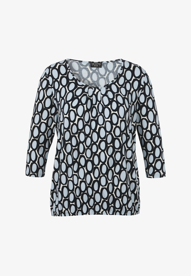 Haut à motifs noir et blanc avec des manches trois-quarts, présentant un design elliptique sur un fond bleu clair et un col rond.