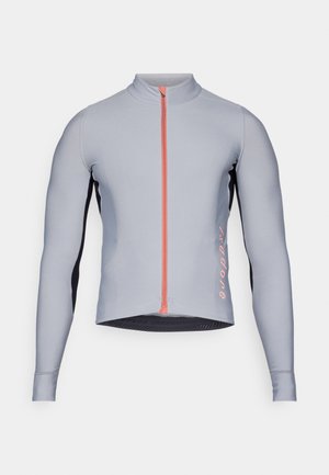 Dlouhý rukáv cyklistický dres v světle šedé barvě s růžovým zipem. Obsahuje černé boční panely a text "isadore" na dolním lemu. Vyrobeno z elastického materiálu.