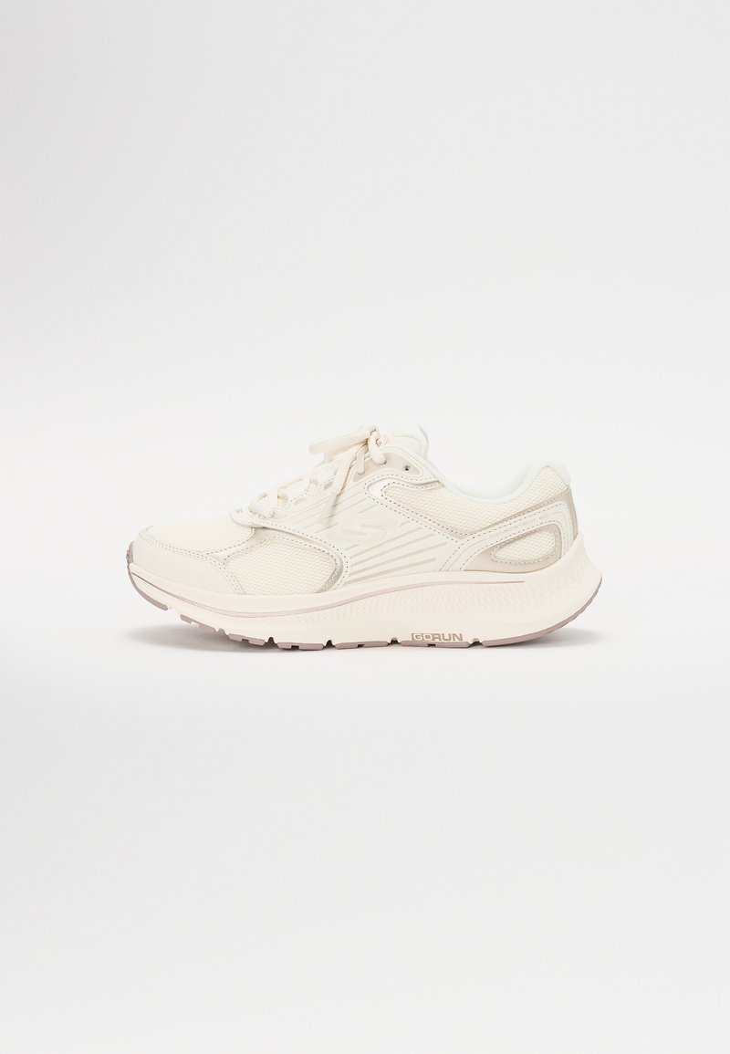 Zapatilla deportiva blanca con parte superior de malla, cuello acolchado y detalles en gris. Presenta una suela texturizada y un sistema de cordones para un ajuste seguro.