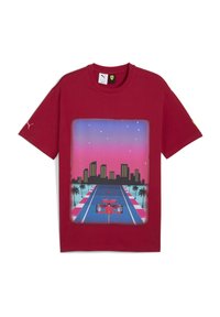 Rød bomulds T-shirt med et grafisk print af en racerbillede på en byvej ved solnedgang, med palmer og bygninger i baggrunden.