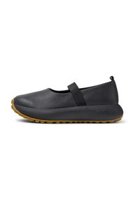 Black leather shoe with a rounded toe, elastic strap, and a rubber sole featuring textured grip. Minimalist design with no visible patterns.