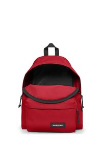 Red Eastpak backpack with black interior, front zip pocket, and top handle, front pocket zipped partially open.