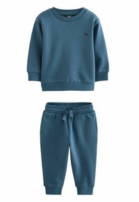 Blaues Baumwoll-Sweatshirt mit gerippten Bündchen und kleinem Logo, kombiniert mit passenden Sweatpants mit elastischem Bund und Seitentaschen.