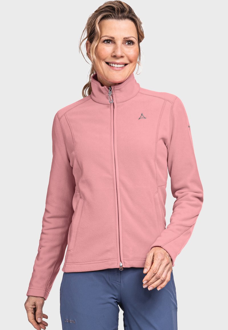 Veste en polaire rose avec col montant, fermeture éclair et poches latérales. Dispose d'un petit logo sur la poitrine et d'une texture lisse.