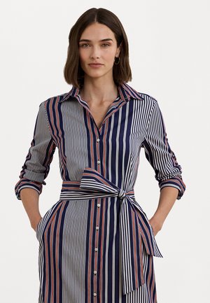 Navy and white striped dress with red accents, button closure, collared neckline, belted waist, and rolled sleeves. Smooth fabric texture.