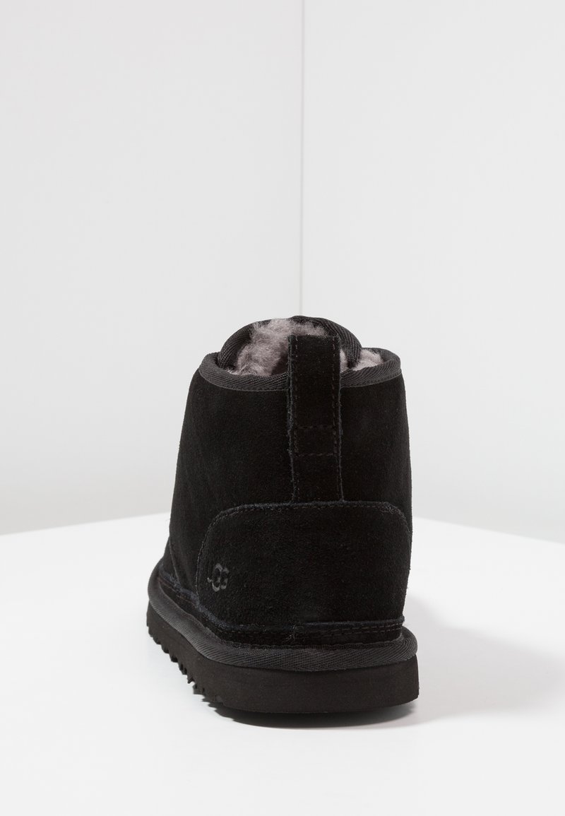 Black suede ankle boot with a plush gray interior lining, featuring a textured rubber sole and a small pull tab at the back.