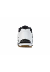 White athletic shoe with black accents, a smooth leather upper, and a textured rubber sole. Features a low profile and cushioned heel.
