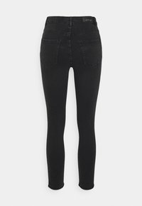 Jean skinny noir taille haute, avec deux poches arrière et des détails de couture subtils. Le tissu a une texture lisse et légèrement extensible.