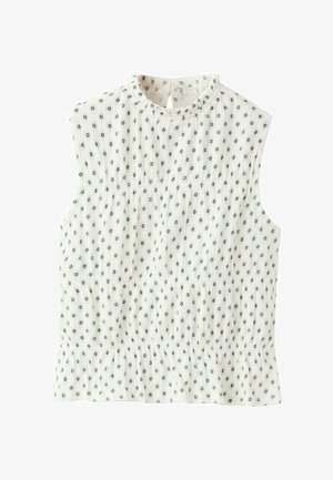 Blouse blanche sans manches avec petit motif de pois bleus circulaires, taille élastique froncée et fermeture à bouton à goutte à l'arrière de l'encolure.