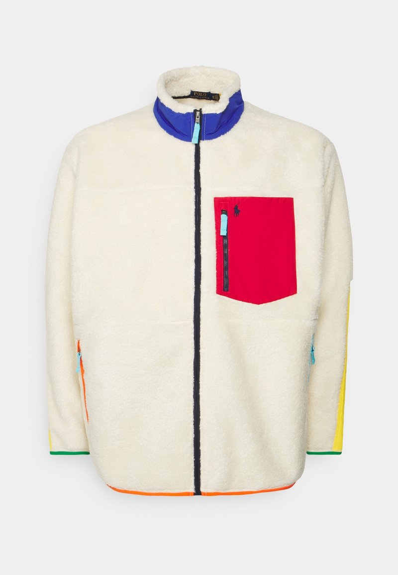 Cream fleece jacket with a blue collar, zippered red chest pocket, and colorful accents in green, yellow, and orange on the sides.