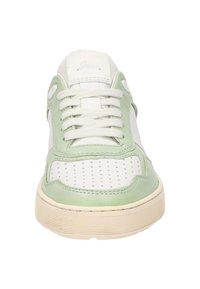 Green and white leather sneaker with perforated sections, laces, and a textured rubber sole. Features a rounded toe and contrasting accents.