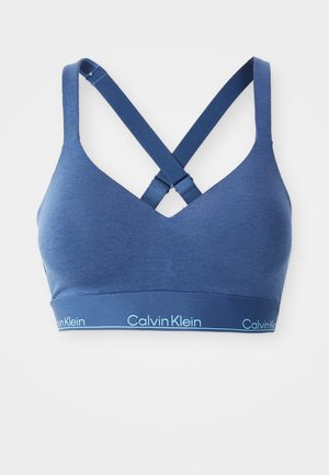 Blauwe katoenmix bralette met een V-hals, kruisbanden op de rug en een contrasterende Calvin Klein-logo band langs de onderkant.