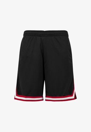 Czarne sportowe spodenki z elastycznym paskiem w talii, z czerwono-białymi paskami w kształcie jodełki blisko brzegu na obu nogawkach.