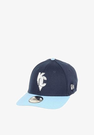 Navy blue cap with light blue visor, featuring a white KC logo on the front. Made from fabric with a smooth texture, structured design.