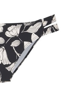Schwarze Bikiniunterteile mit weißem Blumenmuster, das ein hochgeschnittenes Design und doppelte Riemenakzente an den Seiten für eine verstellbare Passform bietet.