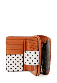 Tan leather wallet with black polka dots on white sections, multiple card slots, zippered pocket, and snap closure. Interior features a gray pattern.