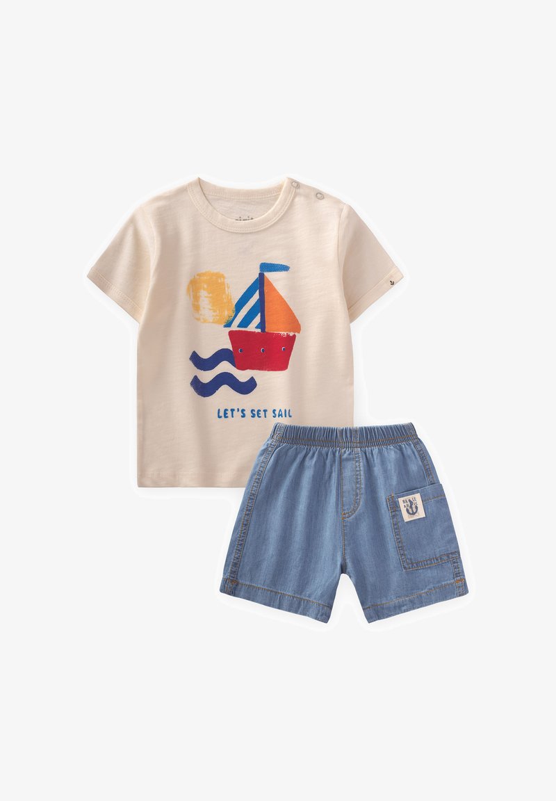 Beige cotton t-shirt with blue, red, and orange boat graphic and text, paired with blue denim shorts featuring an elastic waistband and side pocket.