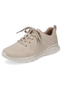 Heled beige spordijalats, millel on kudumülem ja ümar varvas, ning paelaga sulgemine. Omab pehmendatud tallat ja lainekujuline mustrit ning logo aktsenti.