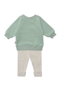Mint green sweatshirt with raglan sleeves and a rounded neckline, paired with light gray ribbed pants featuring rolled cuffs.