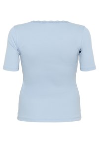 Light blue short-sleeved top made from stretchy fabric. Features a scalloped neckline and fitted design, smooth texture, and simple construction.