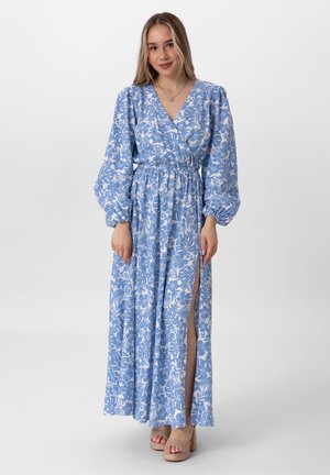 Maxikleid mit blauen Blumenmuster, langen Puffärmeln, elastischem Taillenbund und seitlichem Schlitz. Leichter Stoff mit weißen Blumendetails.