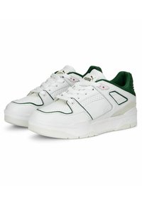 White athletic sneakers with green accents. Made of synthetic leather, featuring perforated details, padded collar, and rubber sole.