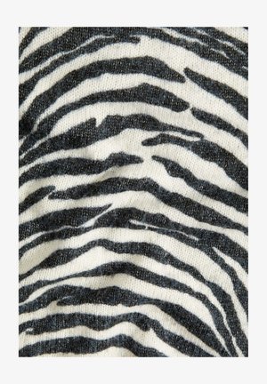 Zebra-patterned fabric in black and white, featuring wavy stripes across a textured, knitted surface. Soft and cozy appearance.