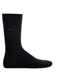 Calzino in cotone nero con una texture a coste, dotato di punta e tallone rinforzati, e un piccolo logo sul lato. Design classico alla caviglia.